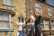Visitors exploring Coronation Street during the behind-the-scenes guided tour in Manchester