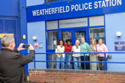 Visitors getting their picture taken in front of Weatherfield Police Station at the Coronation Street Experience