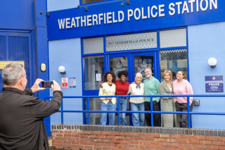 Visitors getting their picture taken in front of Weatherfield Police Station at the Coronation Street Experience
