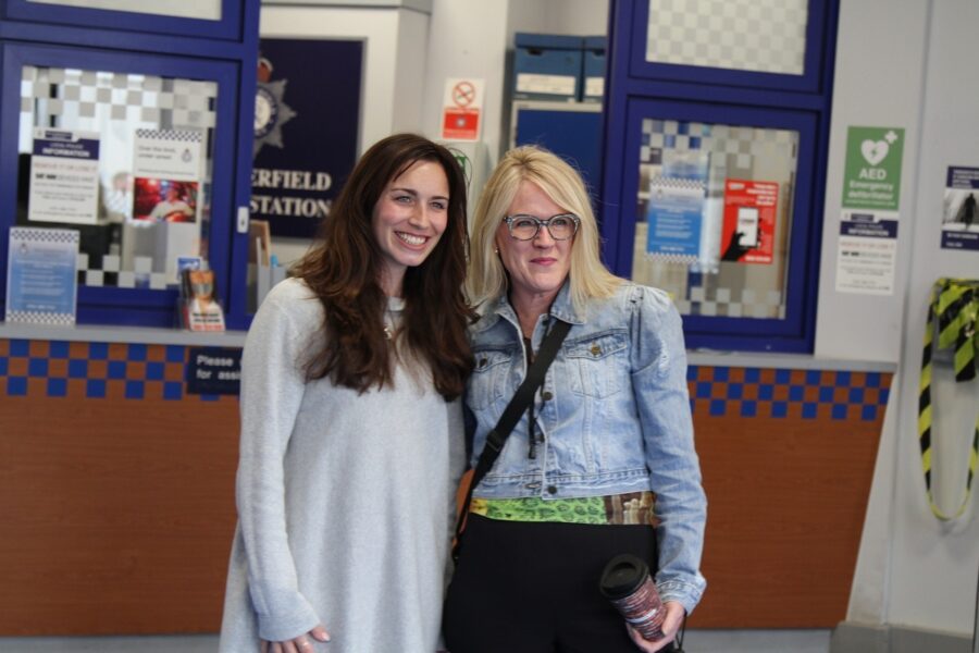 Coronation Street star Julia Goulding, who plays Shona Platt, posing for a photograph with a guest of the Coronation Street Experience.