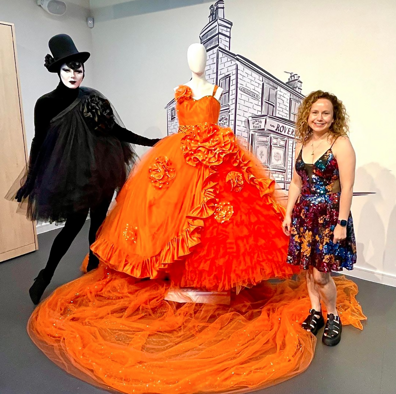 Liquorice Black showcasing her orange wedding dress design, work by Gemma Winter at her wedding