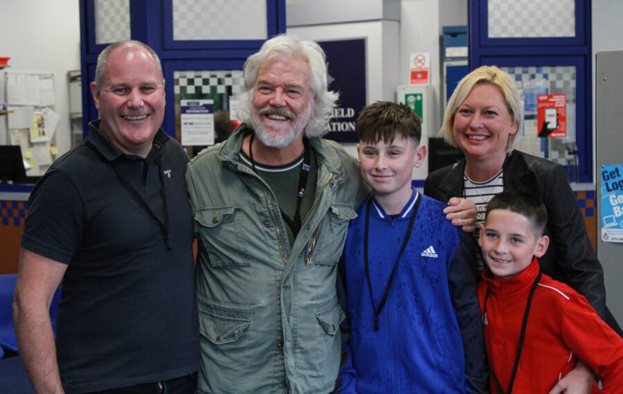 Ted Lasso star Bill Fellows posing for a picture with a family at a meet and greet with Coronation Street casts.