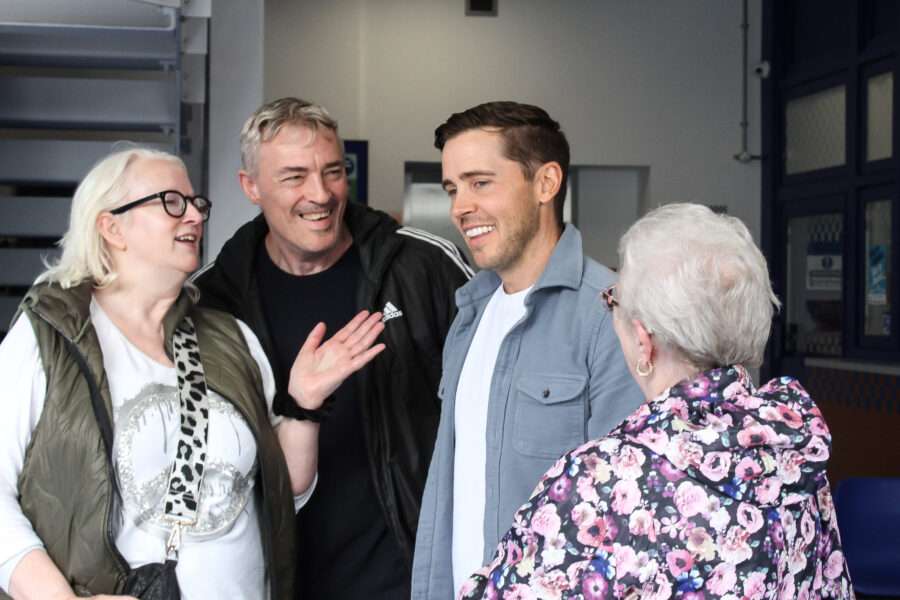 Gareth Pierce, who plays Todd Grimshaw, talking with guests at the Coronation Street Experience.