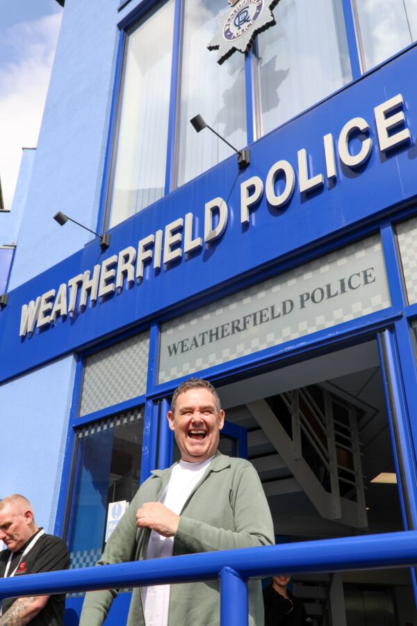 Tony Maudsley, who plays George Shuttleworth, surprises guests of the Coronation Street Experience outside the Weatherfield police station.