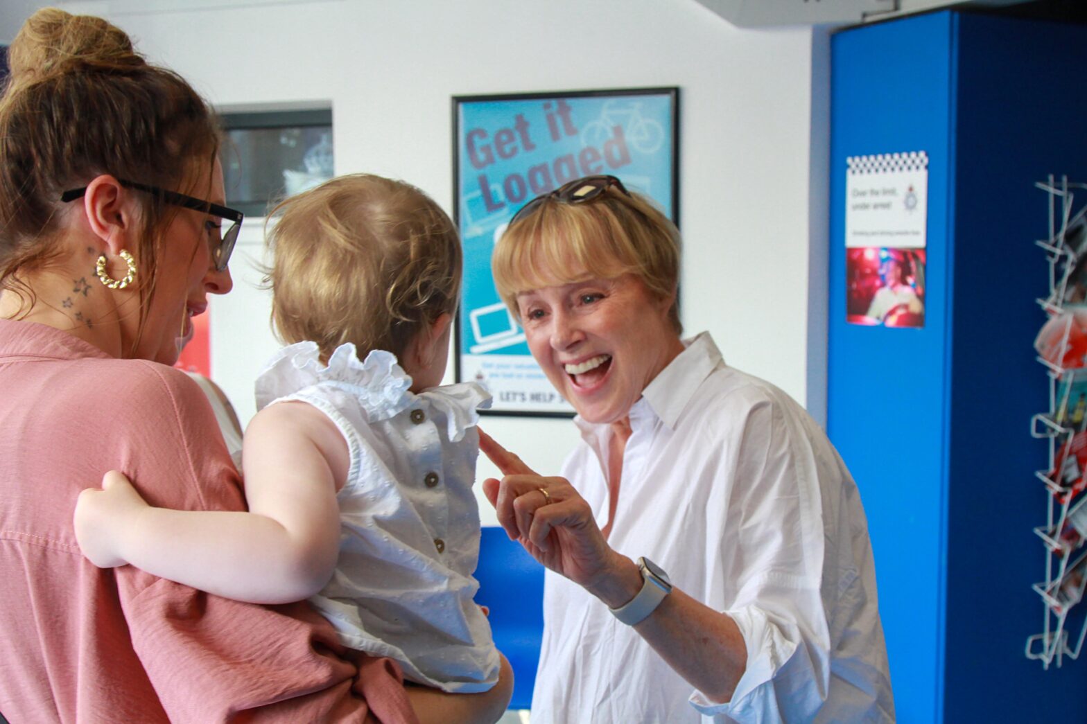 Sally Dynevor at the Coronation Street meet and greet, gently shaking a baby's hand with a warm smile.